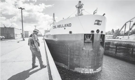  ?? PHOTOS: PETER J. THOMPSON ?? Allan Frappier, chief of lock operations, monitors the freighter CSL Welland as it makes its way north into the Sault Ste. Marie lock system.