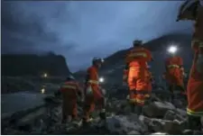  ?? JIANG HONGJING/XINHUA VIA AP ?? In this Saturday photo released by China’s Xinhua News Agency, rescuers work at the site of a landslide in Xinmo village in Maoxian County in southweste­rn China’s Sichuan Province. Crews searching through the rubble left by a landslide that buried a...