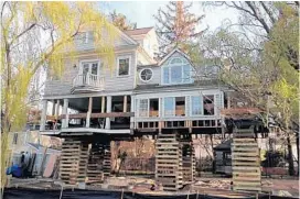  ?? PETER EKVALL/ COURTESY ?? The Ekvalls, of Old Greenwich, Conn., spent more than $ 300,000 to elevate their home, drilling steel pins through the muck below and then lifting the house onto stilts.
