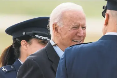  ?? Alex Brandon / Associated Press ?? President Biden, with a Brood X cicada on his shirt collar, walks to board Air Force One at Andrews Air Force Base, Md., on Wednesday. Biden is embarking on the first overseas trip of his term.