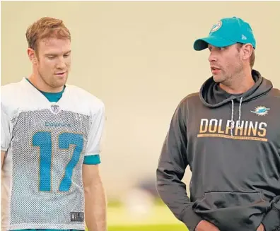  ?? JOHN MCCALL/SUN SENTINEL ?? Dolphins coach Adam Gase, right, says quarterbac­k Ryan Tannehill, left, has “some rare qualities you can’t find in a lot of guys.”