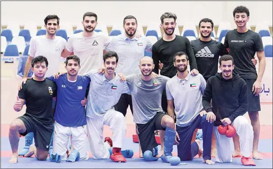  ?? — See Page 14 ?? Kuwaiti athletes pose for a group photo after a training session for the upcoming 3rd Gulf Games, which will be hosted by Kuwait from May 13 to May 31 under the patronage of His Highness the Amir.