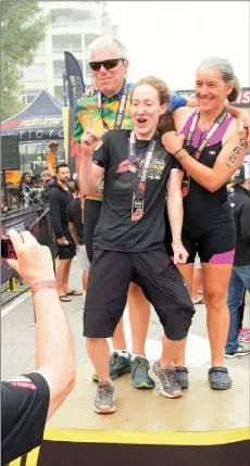  ?? Herald file photo ?? Scott Rose, Andrea Taylor and Anne Condon pose in August for a hazy photo on the podium at the Super League Penticton triathlon, the final day of which was cancelled due to poor air quality from wildfire smoke.