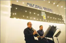  ??  ?? Pavel Vinnitsky, left, and Jonathan Cohen, clarinetis­ts in the Stamford Symphony Orchestra, play inside Half Full Brewery during Symphony on Tap in Stamford on Wednesday.