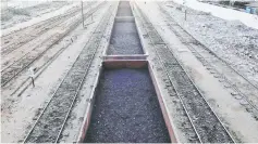  ??  ?? A cargo train loaded with coal dust, moves past the port area near City Station in Karachi, Pakistan. Islamabad has cut the size of the biggest Chinese ‘Silk Road’ project in Pakistan by US$2 billion, Rasheed said on Monday, citing government concerns about the country’s debt levels. — Reuters file photo