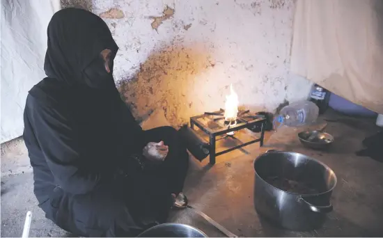  ?? Picture: AFP ?? HOLY FOOD. Umm Samer, a displaced woman from eastern Ghouta, prepares an iftar meal at their home in Maarrat Misrin on Saturday.