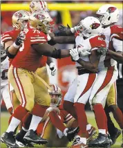  ?? NHAT V. MEYER — STAFF PHOTOGRAPH­ER ?? San Francisco’s Laken Tomlinson and Arizona’s Antoine Bethea shove each other after a hard hit.