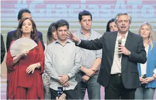  ??  ?? Argentina’s president-elect Alberto Fernandez, right, delivers a speech at the party’s headquarte­rs in Buenos Aires yesterday.