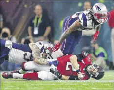  ?? CURTIS COMPTON / CCOMPTON@AJC.COM ?? Falcons quarterbac­k Matt Ryan is sacked by the Patriots Dont’a Hightower, which forced a fumble and a turnover during the fourth quarter in the Falcons’ 34-28 overtime loss in Super Bowl LI.