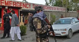  ?? GETTY IMAGES ?? HELPING THE WOUNDED: A Taliban fighter stands guard outside the entrance of a hospital where the victims of an explosion are to be brought, in Kabul on Sunday.