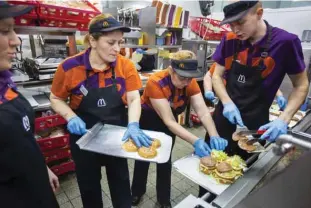  ??  ?? MOSCOW: Workers deliver food in a McDonald’s restaurant in Moscow, Russia. A long-standing policy to source as many ingredient­s as possible locally has paid off for the US fast-food giant, which says it serves 1.1 million customers a day in Russia....