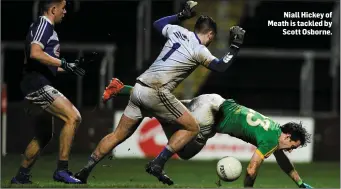  ??  ?? Niall Hickey of Meath is tackled by Scott Osborne.