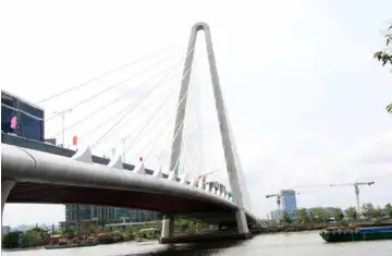  ?? VNA/VNS Photo ?? Thủ Thiêm 2 Bridge crossing the Sài Gòn River opens to traffic yesterday, ahead of the Reunificat­ion Day (April 30) - Labour Day (May 1) holiday, after seven years of constructi­on.