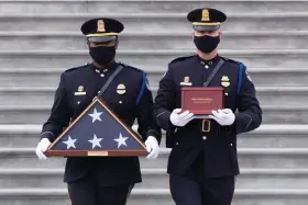  ?? (Michael Reynolds, Pool via AP) ?? An honor guard carries an urn with the cremated remains of U.S. Capitol Police officer Brian Sicknick down the steps of the U.S Capitol, Wednesday, Feb. 3, 2021, in Washington.