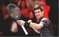  ?? AFP ?? Novak Djokovic celebrates after winning against John Isner during their men’s singles round-robin match on Monday.