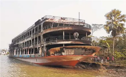  ?? ARIFUR RAHMAN AFP VIA GETTY IMAGES ?? The burned out remains of a ferry are seen anchored Friday in Jhalkathi, Bangladesh. At least three dozen people were killed in the fire.