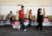  ?? JOHN LOCHER / ASSOCIATED PRESS ?? Members of the Culinary Union carry signs at a union hall Friday in Las Vegas. A deal between MGM Resorts Internatio­nal and the Culinary Workers Union Local 226 was announced by the union in a tweet late Saturday.