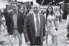  ?? REUTERS FILE ?? Gregory Abel, the CEO of Berkshire Hathaway Energy designated to succeed Warren Buffett as Berkshire CEO, walks through the crowd at the annual meeting in Omaha, Nebraska, on April 29.