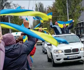  ?? ?? JUBILANT: Ukrainians celebrate on the streets of central Kherson yesterday after its liberation. The Russians had occupied the city since early March