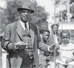  ?? ASSOCIATED PRESS FILE PHOTO ?? Blues legend W.C. Handy is pictured with an unidentifi­ed child on a swing.