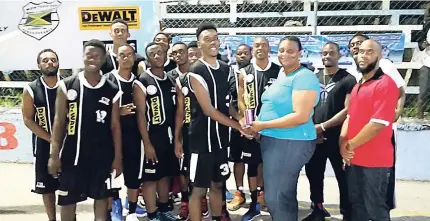  ??  ?? The Montego Bay Boys and Girls Club Warriors team collecting the trophy for winning the Western Basketball Associatio­n Division One Basketball League on Sunday.