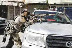  ?? Reuters ?? A foreign soldier takes position during an attack and gunfire in Kabul.