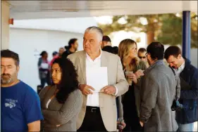  ?? WADE VANDERVORT ?? Democratic gubernator­ial candidate Steve Sisolak waits in line with other voters Tuesday at Kenny Guinn Middle School.