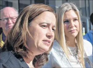  ?? ANDREW VAUGHAN/CP PHOTO ?? Nadine Larche, left, wife of Const. Doug Larche and Rachael Ross, wife of Const. Dave Ross, talk with reporters at the Law Courts in Moncton, N.B. on Friday. The RCMP has been convicted of violating the Labour Code for failing to provide its members...