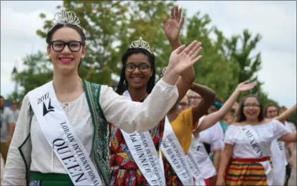  ?? ERIC BONZAR — THE MORNING JOURNAL ?? Lorain Internatio­nal Queen Madison Maniaci leads the parade of princesses through Black River Landing, signifying the start of the 51st annual Lorain Internatio­nal Festival, June 23.