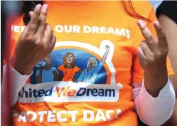  ?? Yi-Chin Lee/Houston Chronicle via AP ?? ■ United We Dream youths and allies snap their fingers to show support to other DACA recipients speaking to the media after a court hearing in a lawsuit filed by states challengin­g DACA program at the United States District Courthouse on Wednesday in Houston.