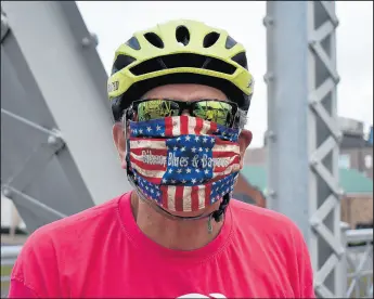  ?? ADAM BAKST/AP ?? Parker Hall shows off his custom-made “Bikes, Blues and Bayous” face mask before the 13th annual Bikes, Blues Bayous cycling event in Greenwood, Mississipp­i, on Aug. 1.