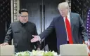  ?? Evan Vucci ?? The Associated Press President Donald Trump gestures toward North Korea leader Kim Jong Un before a document signing Tuesday at the Capella resort in Singapore.