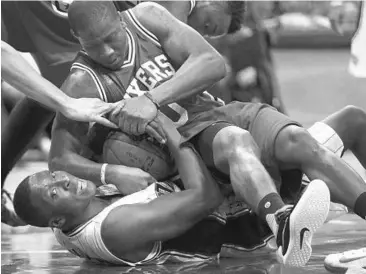  ?? CHARLES KING/STAFF PHOTOGRAPH­ER ?? Magic G Victor Oladipo, bottom, delivered 28 points in Sunday’s 130-116 victory over the 76ers and Isaiah Canaan.