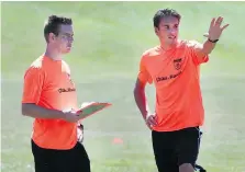  ??  ?? Rene Van Baren, left, and Pasquale Hoekman, soccer instructor­s from the Netherland­s, give instructio­n at a soccer camp in Tecumseh on Friday.