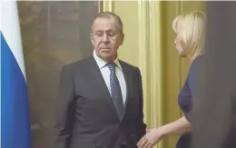  ?? AP PHOTO ?? QUID PRO QUO: Russian Foreign Minister Sergey Lavrov listens to Foreign Ministry spokeswoma­n Maria Zakharova, right.