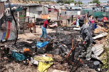  ?? Picture: Phando Jikelo/African News Agency/ANA ?? GUTTED: Residents of Siqalo informal settlement rebuilding their homes after the fire yesterday.