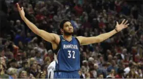  ?? STEVE DYKES — THE ASSOCIATED PRESS FILE ?? In this file photo, Minnesota Timberwolv­es center Karl-Anthony Towns celebrates after hitting the game-winning shot in a game against the Portland Trail Blazers April 9 in Portland, Ore.