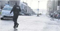  ?? MARK JAMIESON ?? Police at the scene of the shooting in Garvagh