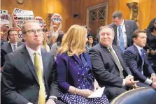  ?? JACQUELYN MARTIN/ASSOCIATED PRESS ?? Secretary of State-designate Mike Pompeo, second from right, awaits his confirmati­on hearing by the Senate Foreign Relations Committee Thursday with wife Susan and son Nick, left.