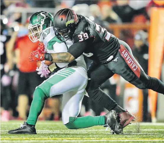  ?? AL CHAREST ?? Roughrider­s quarterbac­k Kevin Glenn is sacked by Stampeders pass rusher Charleston Hughes during first quarter action on Friday night at McMahon Stadium. The Calgary defence knocked Glenn out of the game but that didn’t slow down the Riders, who won...