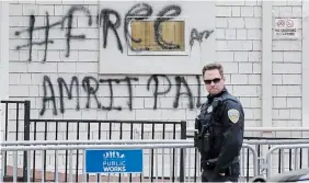  ?? JEFF CHIU THE ASSOCIATED PRESS ?? San Francisco police have erected barriers and parked a vehicle nearby as people protested outside the Consulate General of India to protest the manhunt of Sikh separatist leader Amritpal Singh.