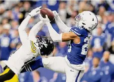  ?? Andy Lyons/Getty Images ?? The Colts’ Nick Cross intercepts a pass intended for Steelers receiver George Pickens in the second quarter on Saturday in Indianapol­is.