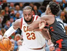  ?? AP-Yonhap ?? Cleveland Cavaliers’ LeBron James, left, drives past Toronto Raptors’ OG Anunoby during the first half of an NBA basketball game in Cleveland, Tuesday.