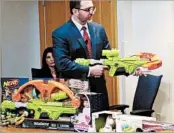  ?? PHILIP MARCELO/AP ?? WATCH director James Swartz uses Nerf ’s “Zombie Strike” crossbow, which the nonprofit says poses a safety hazard.