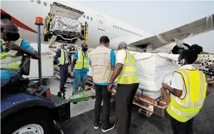  ?? FRANCIS KOKOROKO THE ASSOCIATED PRESS ?? The first shipment of COVID-19 vaccines distribute­d by the COVAX facility arrives at the Kotoka Internatio­nal Airport in Accra, Ghana, on Wednesday.