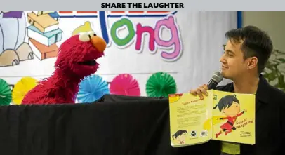  ??  ?? Elmo shares a light moment with storytelle­r Rich Rodriguez.