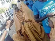  ?? CONTRIBUTE­D BY BABALE ABUBAKAR ?? These two schoolgirl­s were among dozens kidnapped more than a month ago. Boko Haram militants returned them to Dapchi, Nigeria, on Wednesday. The militants gathered residents around them and warned them not to send the girls back to school.