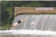  ?? STAFF FILE PHOTO ?? A teenager dives off the dam at Marion County’s Ketner’s Mill.