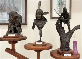  ?? Spencer Bailey/Herald-Leader ?? Three of Troy Anderson’s signature bronze sculptures sit on display at the Siloam Springs Museum in anticipati­on of his open house on March 4.