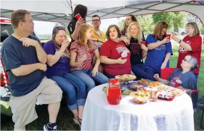  ??  ?? When planning a tailgating party, the menu — and, of course, the company — is almost as important as the game itself. Members of the Three Rivers Edition team pooled their resources to create this outdoor extravagan­za.